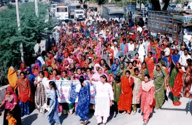 A large group of women marching on the street with banners
